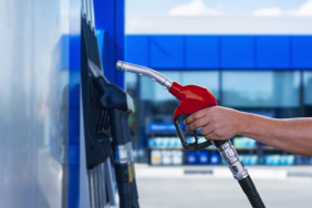 Man holds a refueling gun in his hand for refueling cars. Gas station with diesel and gasoline fuel close-up.